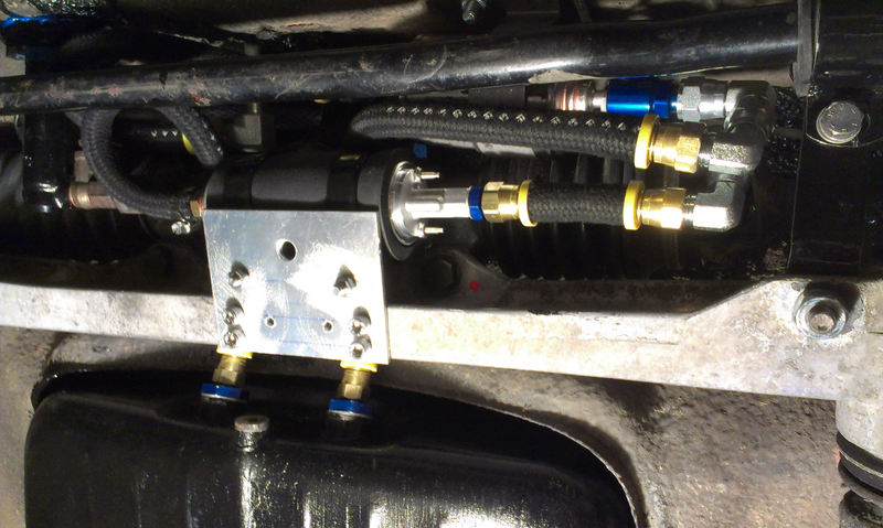 Details of the fuel system components next to the steering rack.
